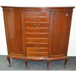 An unusual Edwardian mahogany shaped breakfront music cabinet, moulded top,