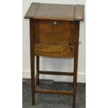 An oak sewing cabinet with drawer