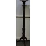 A mahogany torchere, serpentine square top, turned, fluted and carved column, three cabriole legs,