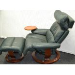 An Ekornes Stressless recliner with moveable wine table attachment; a conforming footstool.