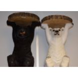 A pair of resin garden stools, as bears, one black,