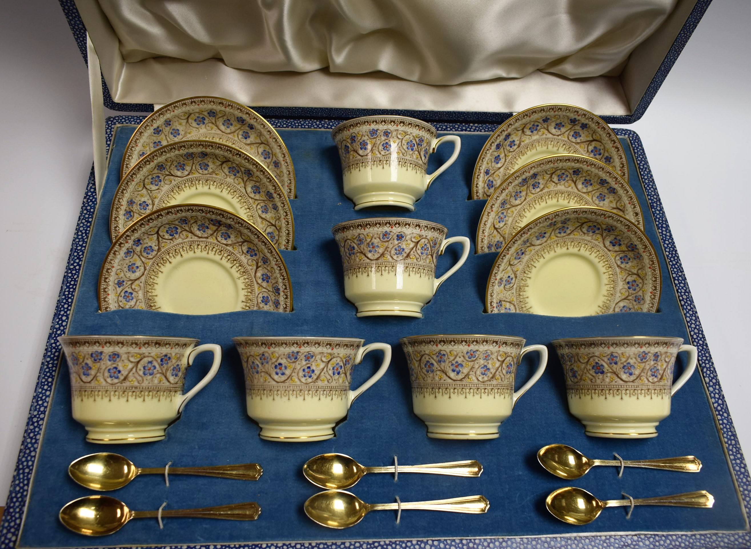 A Royal Worcester Lady Evelyn pattern coffee service, for six, six gilt coffee spoons ensuite,