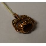 A hallmarked 9ct gold swivel Albert fob, set onyx,