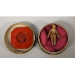 An early 19th century miniature wooden peg doll and seal