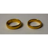 A 22ct gold wedding ring, size I; another size H, 6.