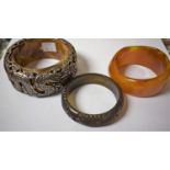 Jewellery - A silver coloured metal and cloud amber coloured dragon bangle, unmarked,