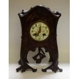 An Art Nouveau style French spelter mantel clock, the arched case cast with a classical maiden,