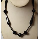 A Victorian carved jet bead necklace, composed of nine principle spiral and faceted beads,