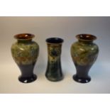 A pair of Royal Doulton tube lined vases; another,