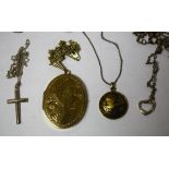 A large rolled gold locket; two silver pendants;