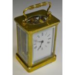 A brass carriage clock, Roman numerals,