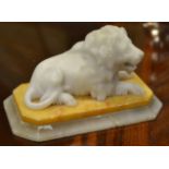 A late 19th century marble and alabaster model of a lion, seated, canted rectangular base,