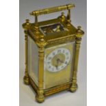 An early 20th century brass carriage clock, white enamel chapter ring,