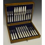 An early 20th century mahogany cased mother of pearl hafted fruit knives and forks,