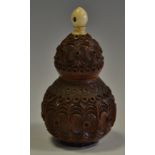 A 19th century carved cocquilla nut of gourd form,