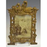 A Victorian gilt metal photograph frame, cast with a frog, lily pads and swans, c.
