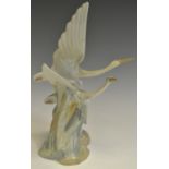 A LLadro Nao figure, Two Cranes in Flight, wavy clouds,