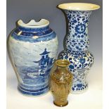 A large Chinese blue and white gu vase (faults); another; an Oriental monochrome stoneware vase,