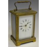 An early 20th century lacquered brass carriage timepiece