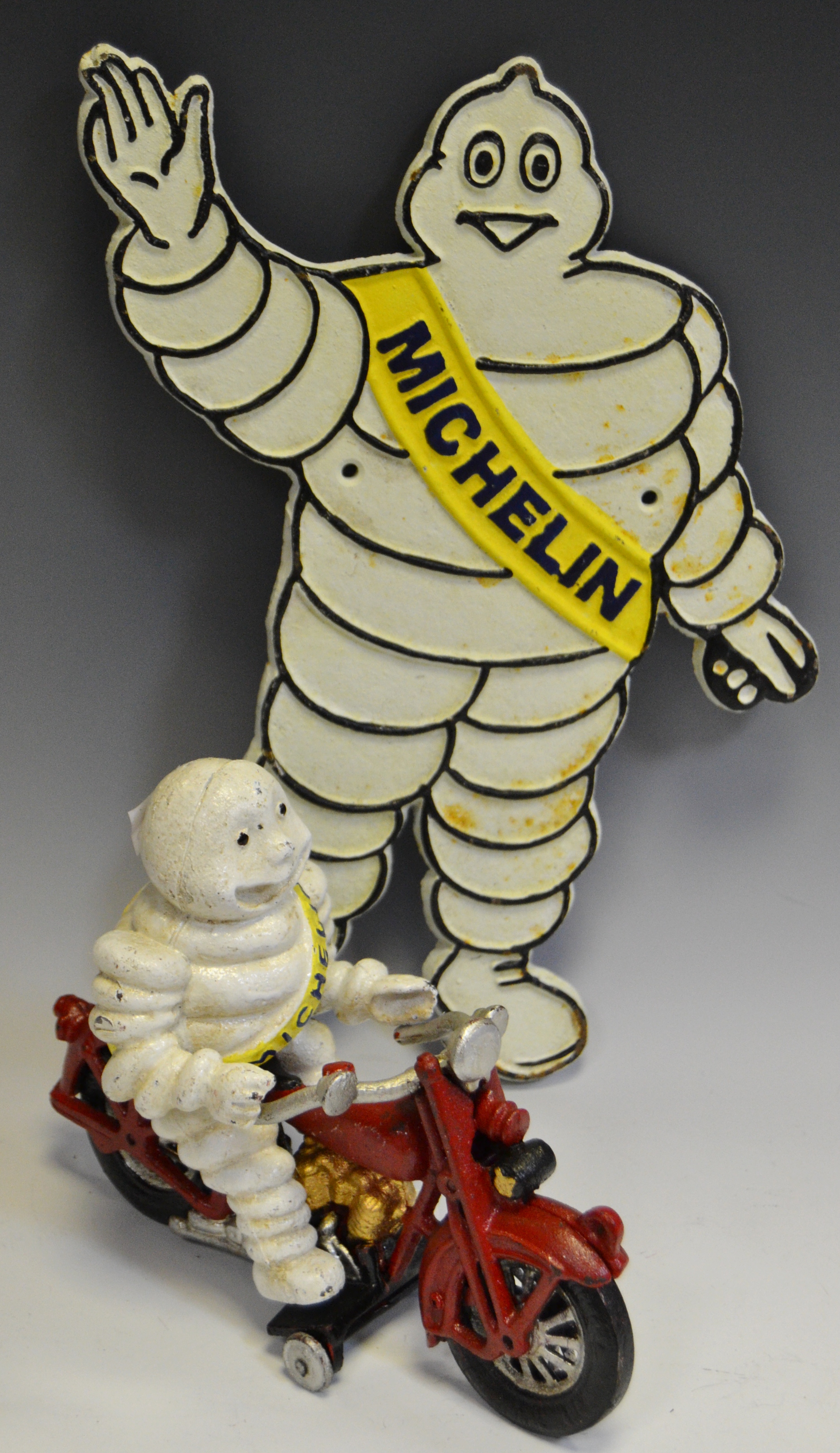 A Reproduction Michelin Man cast sign;