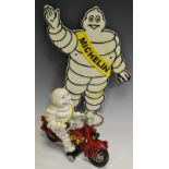 A Reproduction Michelin Man cast sign;