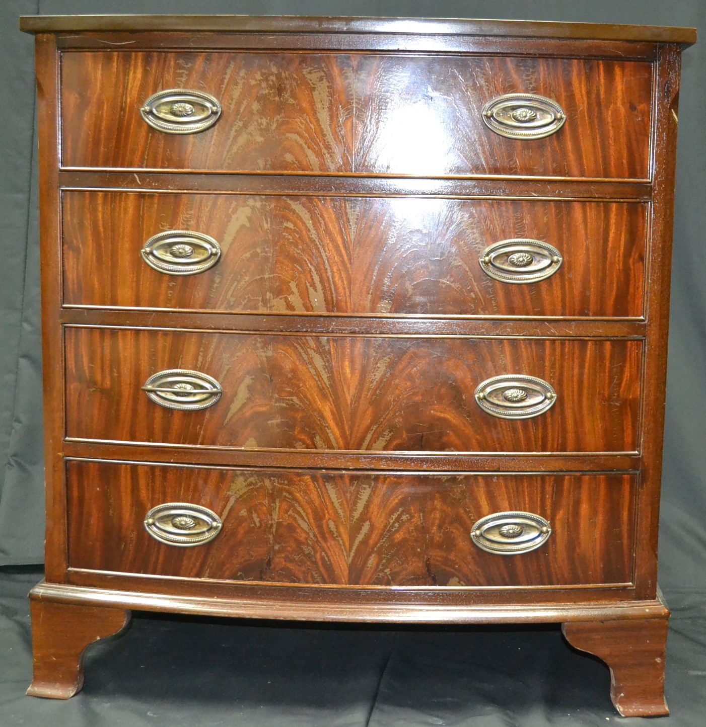 A reproduction mahogany bow front chest of drawers