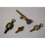 A collection of four 19th century agate mounted pocket watch keys