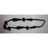 A Victorian carved jet bead necklace, composed of nine principle spiral and faceted beads,