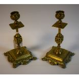 A pair of ornate Victorian brass candlesticks