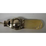 A silver whistle, mother of pearl handle,