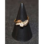 A diamond and white sapphire nine stone ring, raised central round brilliant cut diamond, approx 0.
