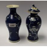A Chinese blue and white baluster vase and cover, another similar,