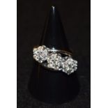 A diamond triple head cluster ring, each floral head inset with seven round brilliant cut diamonds,