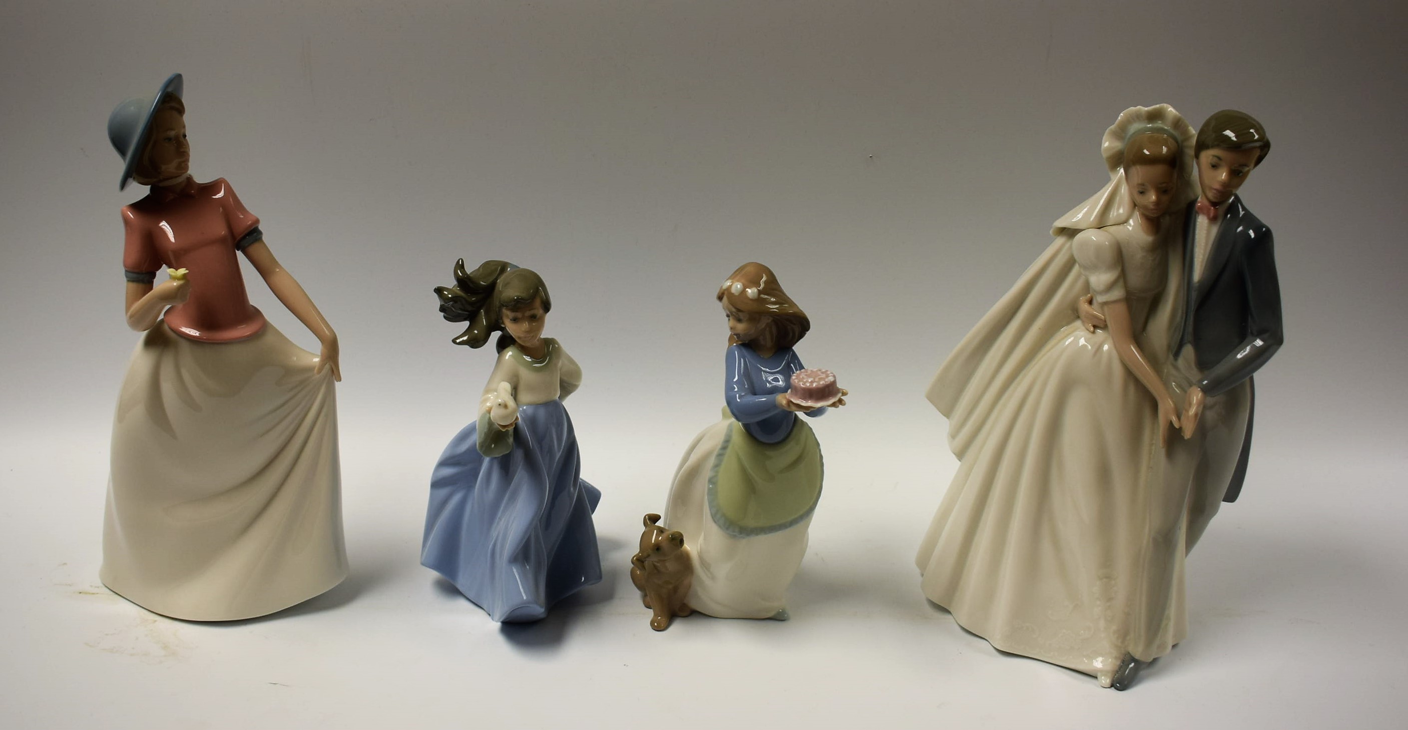 A Nao Spanish porcelain figure group The Bride and Groom; other Nao porcelain figures,