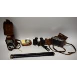 A pair of Carl Zeiss Jena binoculars, DF 8X, serial number 585856; an Agfa Isolette 35mm camera,