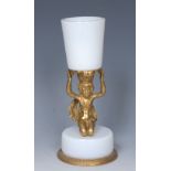 A 19th century French gilt-metal and opaque glass figural spill holder,