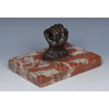 A 19th century brown patinated bronze desk weight, cast as a clenched fist,