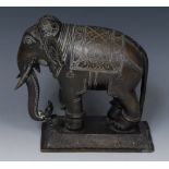 A 19th century Indian brown patinated bronze, of an elephant, the beast stands four square,