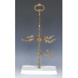 A 19th century gilt-metal table-top wine bottle stand, the central post with sprung mechanism,