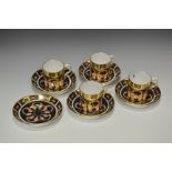 **Derby**A set of four Royal Crown Derby 1128 pattern coffee cup and saucers; a similar saucer;