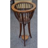 An early 20th century mahogany jardiniere stand