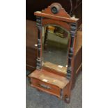 An early 20th century mahogany ebonised hall mirror, hinged glove box, c.