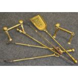 A Regency style style brass fire iron, three others similar,