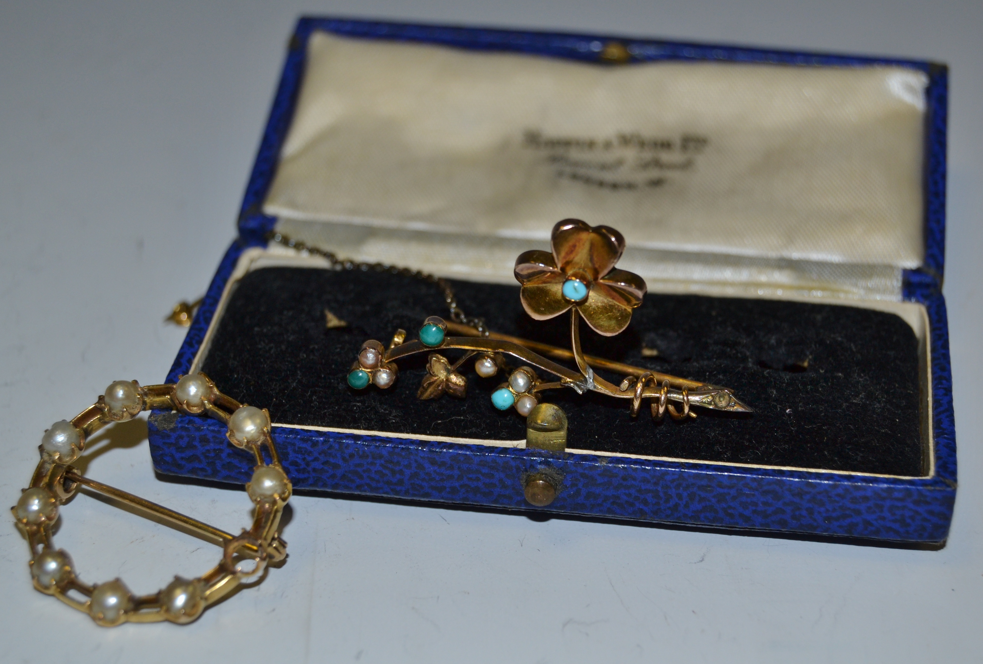 A 9ct gold bar brooch in the form of clover leaf and foliage set with turquoise and seed pearls;