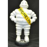 A reproduction cast metal figure of Bibendum - 15" Michelin man standing on tyre