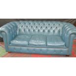 An Andrew Muirhead blue leather three seat Chesterfield sofa.