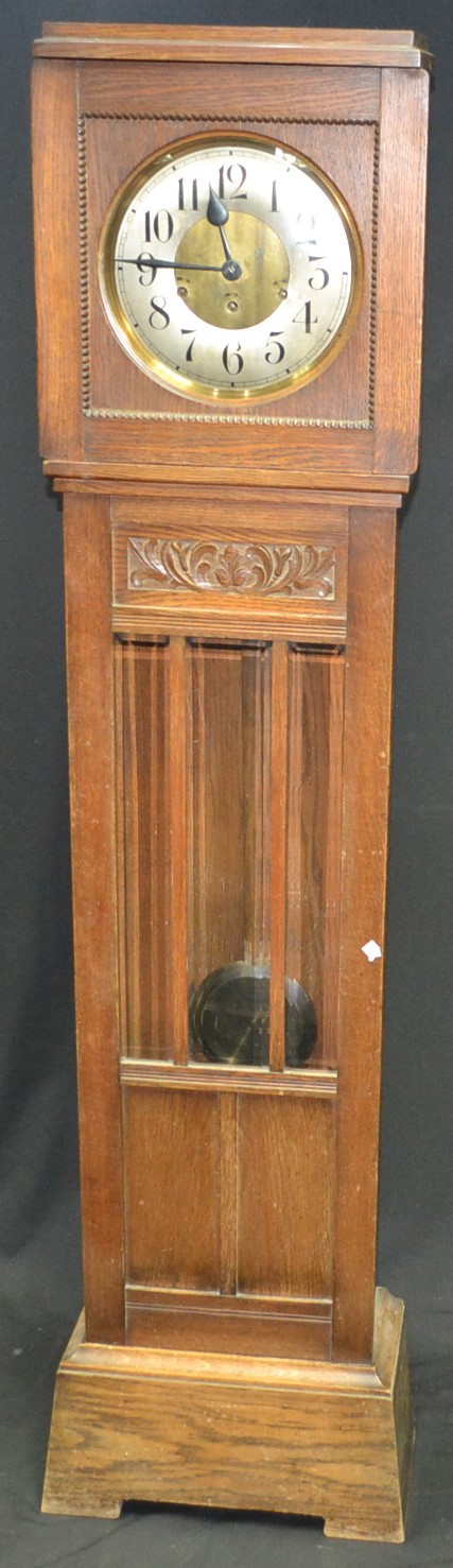 An Art Deco oak cased chiming Grandfather clock