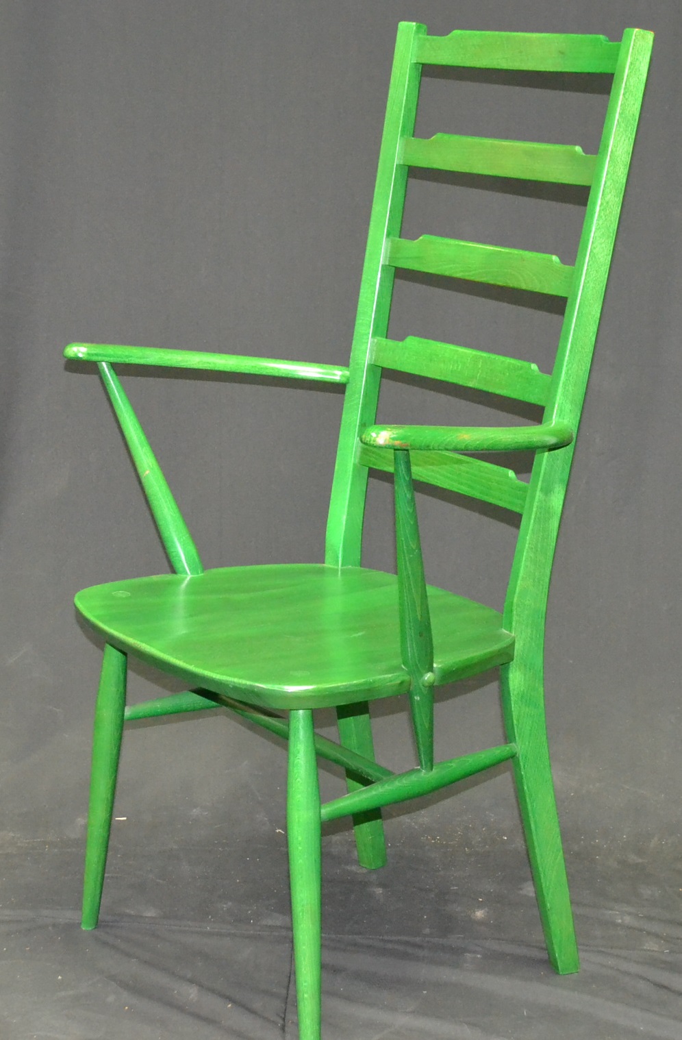 A green Ercol ladder back chair