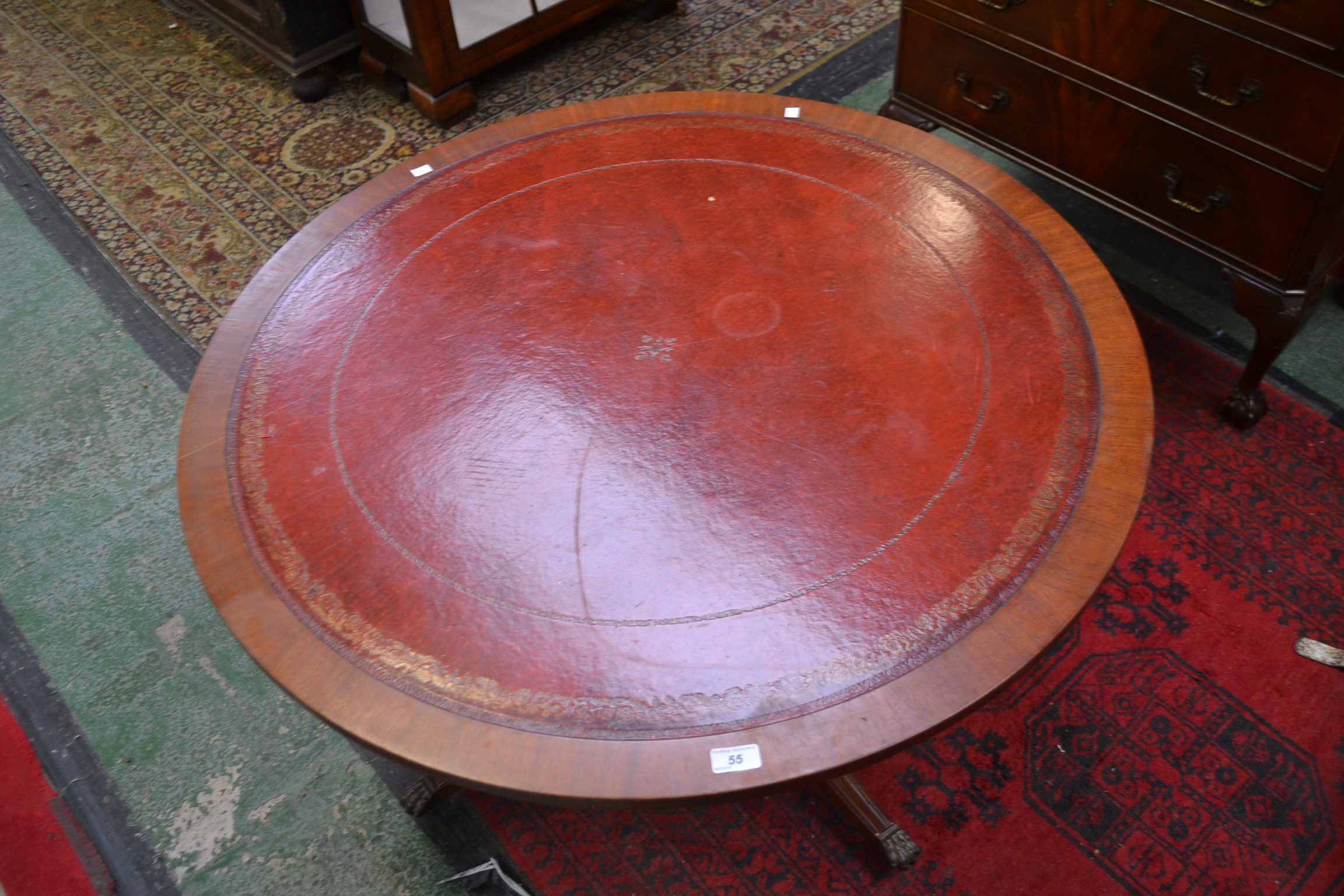 A Reprodux mahogany circular coffee table,