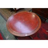 A Reprodux mahogany circular coffee table,